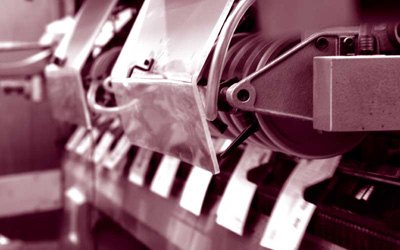 Close-up of an offset press unit mid-run